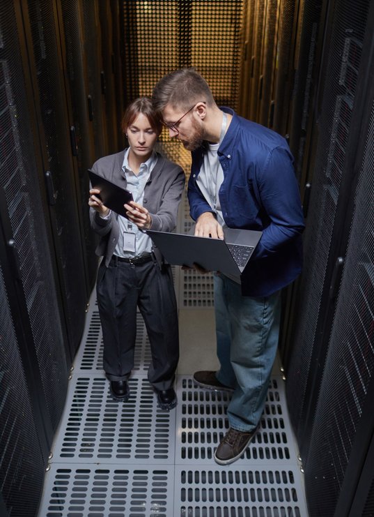 examining-data-on-tablets-in-a-server-room-2025-07-20-22-12-08-utc
